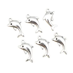 Set of 6 silver alloy dolphin charms for DIY jewelry making on white background