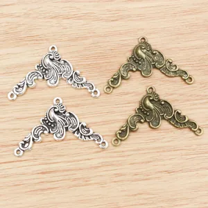 Detailed macro view of vintage alloy peacock flower jewelry connectors in silver and bronze