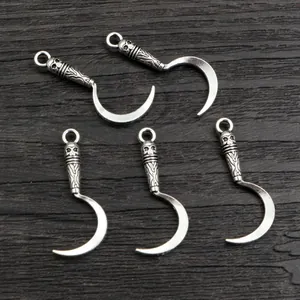 Five vintage silver alloy scythe pendants with skull carvings for DIY jewelry making