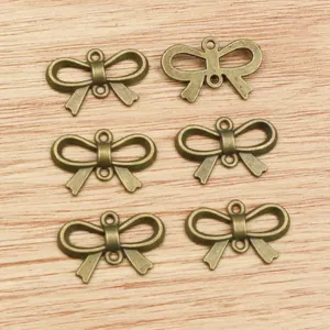 Set of 6 bronze alloy bow-shaped charms with double loops for DIY jewelry making