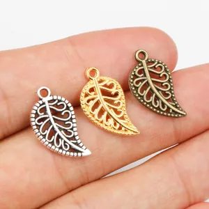 Three-color leaf charm set for DIY jewelry making held in hand to show scale
