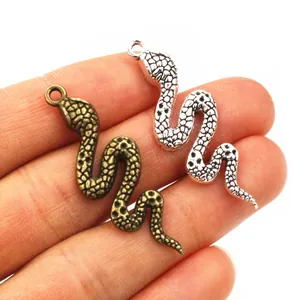 Macro shot of snake charms in antique bronze and silver finish for DIY jewelry making