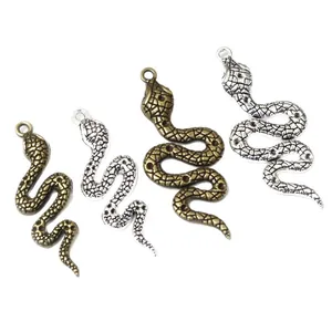 Set of four vintage alloy snake charms in antique bronze and silver for DIY jewelry
