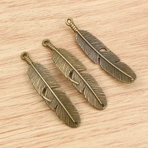 Three antique bronze feather pendants 57x13mm with detailed texture for DIY jewelry making