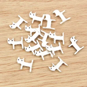 Alloy cat silhouette pendants scattered on wood surface for DIY jewelry making