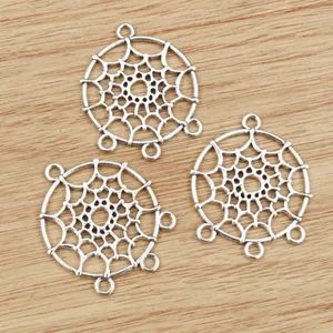 Three silver dreamcatcher alloy pendant connectors for DIY jewelry making on wood