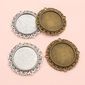 Detailed view of 25mm double-sided filigree pendant trays in silver and bronze colors
