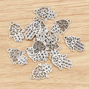 Hamsa Hand pendants in antique silver finish for DIY jewelry making on wood background