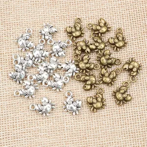 Detailed top view of alloy crab charms in silver and bronze for DIY jewelry making