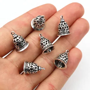 Six pieces of vintage silver brass 3D bell pendants with hollow carved patterns on palm