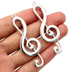 Silver treble clef musical note alloy charms held in hand for jewelry DIY