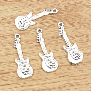 Retro silver alloy guitar pendants with embossed string details on wood background