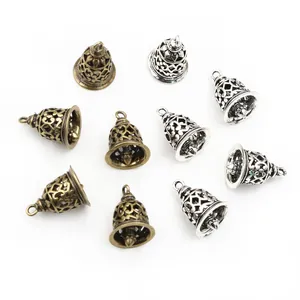 Detail of vintage 3D hollow bell charms in antique bronze and silver for DIY jewelry