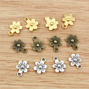 Detalle macro de colgantes de flores en oro plata y bronce para la creación de joyas DIY