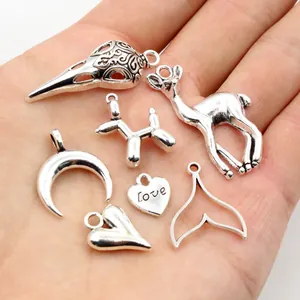 Detailed close-up of retro silver alloy charms including love heart and animal designs