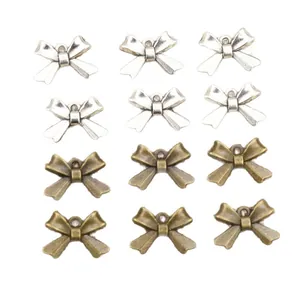 Alloy bow pendants in silver and bronze colors for DIY jewelry making and crafts