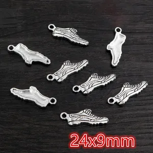 Macro detail of antique silver alloy sneaker charms for DIY jewelry making 24x9mm