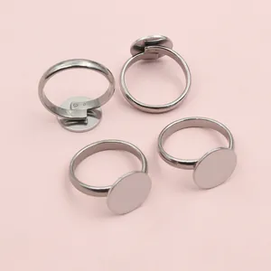 Detailed view of four adjustable silver stainless steel ring bases for DIY jewelry making