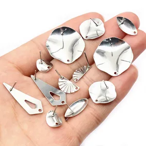 Detailed display of irregular stainless steel earring bases for DIY jewelry making in palm