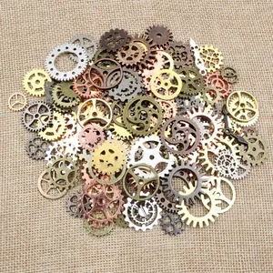Detail of mixed steampunk alloy gears and clock hands for DIY jewelry on burlap