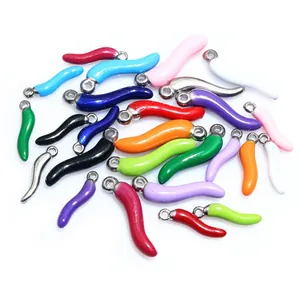 Macro view of colorful enamel chili pepper pendants for DIY jewelry making and crafts
