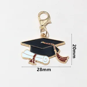 Detail of graduation cap and diploma charm with lobster clasp measuring 28mm by 20mm