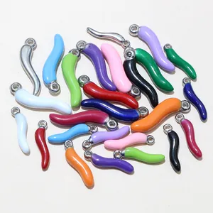 Detailed view of colorful stainless steel chili pendants with polished enamel finish
