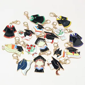 Detail of graduation enamel charms with gold lobster clasps and colorful robes