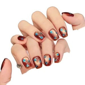 Cat eye brown press-on nails with blue floral sequins and squoval shape finish
