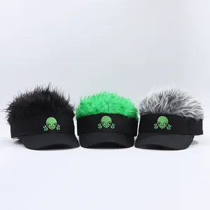 Detail of alien embroidery and faux hair hairpieces in black, green, and gray wig visors