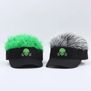 Detail of green and silver synthetic hair wigs attached to baseball caps with alien embroidery