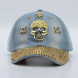 Close-up of denim baseball cap with gold skull studs and rhinestone encrusted brim
