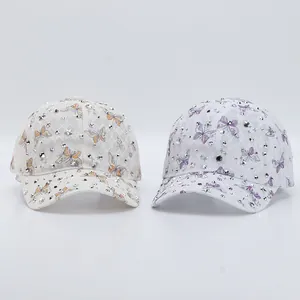 Détail de casquettes en dentelle avec des strass et des motifs de papillons colorés