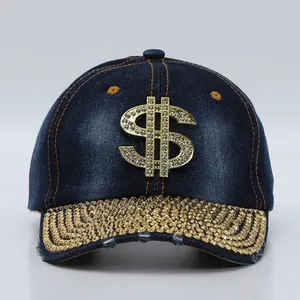 Close-up of sparkling gold rhinestones and metallic dollar sign on a denim baseball cap
