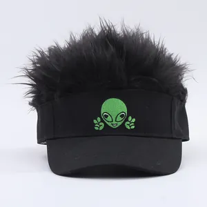 Detail of creative black visor hat with green alien embroidery and shaggy wig hair topper