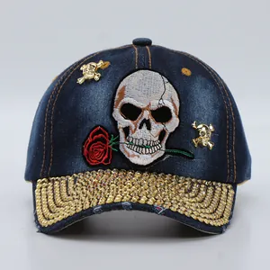 Close-up of denim baseball cap with skull rose embroidery and rhinestones on the brim