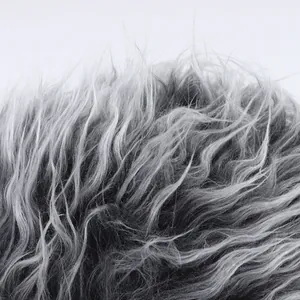 Macro shot of dense grey gradient faux fur texture on alien wig baseball cap
