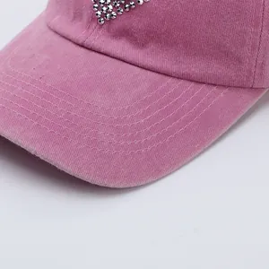 Pink washed cotton baseball cap with silver rhinestone heart and curved stitch brim