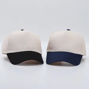 Close-up of two-tone cotton baseball caps in beige with black and navy blue visors