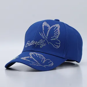 Detailed view of the royal blue cotton cap with butterfly pattern in colorful rhinestones