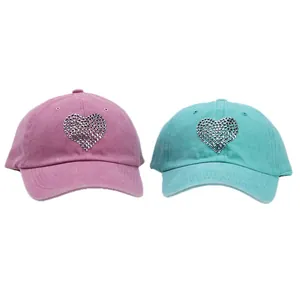 Washed cotton baseball caps in pink and blue featuring rhinestone heart decorations