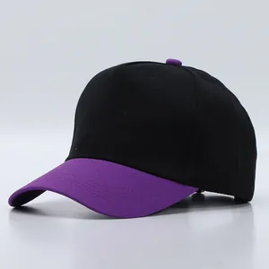 Detail view of cotton baseball cap showing black crown with purple brim and contrast button