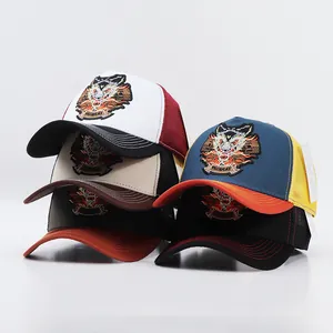 Detail of embroidered wolf patches on multi-colored breathable mesh trucker hats