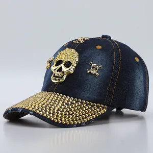Deep blue denim baseball cap with gold skull emblem and rhinestone brim detail