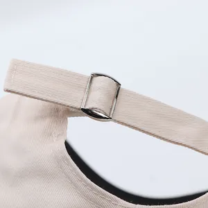 Detail view of cotton baseball cap with adjustable metal buckle and twill fabric