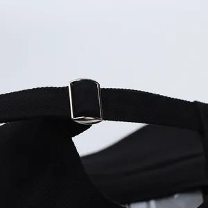 Detail of black cotton baseball cap showing adjustable back strap and silver metal buckle