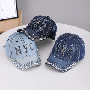 Denim baseball caps with rhinestone NYC logo in light, medium, and dark blue wash