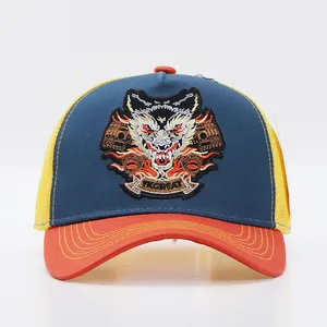 Close-up of heavy embroidery wolf patch on blue and yellow trucker baseball cap