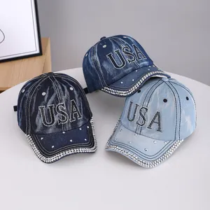 Detailed shot of three denim baseball caps in blue shades with sparkling USA rhinestone decor