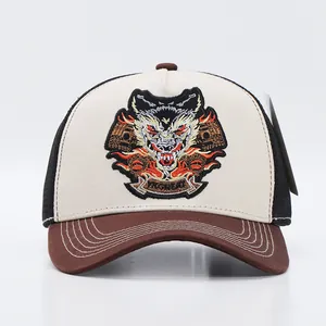 Detail of embroidered wolf patch on a bicolor mesh trucker hat with decorative stitching